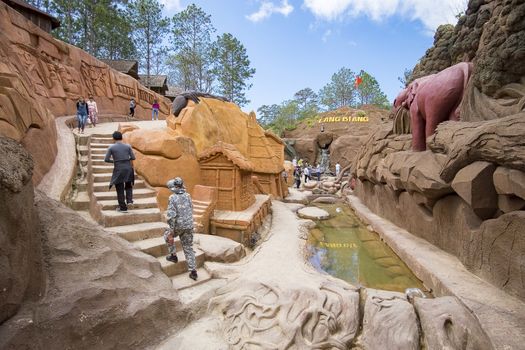 Amazing destination for Vietnam tourism, work of art know as sculpture tunnel from clay, crowd of traveller traveling architecture work in forest