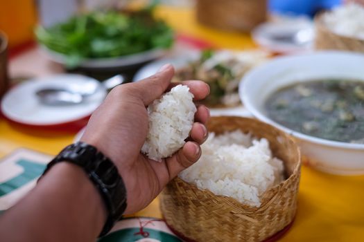 Food container for sticky rice on hand. Vientiane, Lao