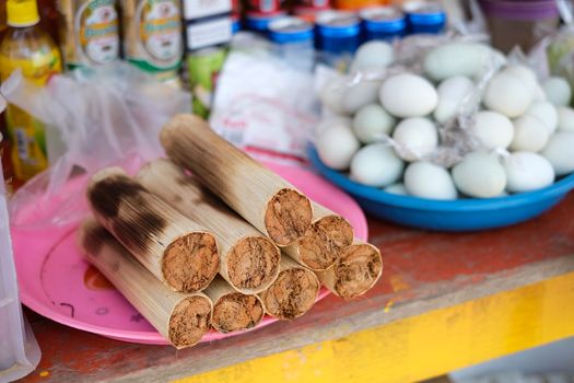 Khao Larm (Bambo rice) at market. Bamboo rice is a type of short grained white rice that has been treated with bamboo juice during milling