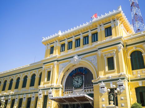 View on the central French colonial style post office with tourist taking some photos in Ho Chi Minh city (Saigon), Vietnam