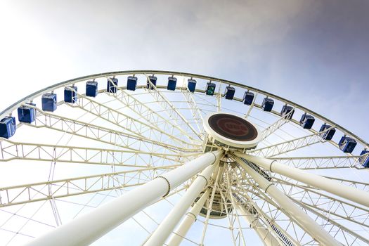 Chicago, IL, USA, october 28, 2016: Gondolas move passengers via hub of the newly opened Dutch Ferris Wheel with baseball tema Cubs logo in the centre