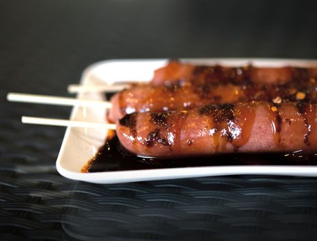 COLOR PHOTO OF SAUSAGES WITH SPICY SAUCE