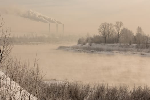 Winter frost haze landscape on the river in the fog