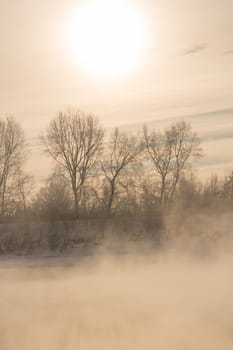 Winter frost haze landscape on the river in the fog