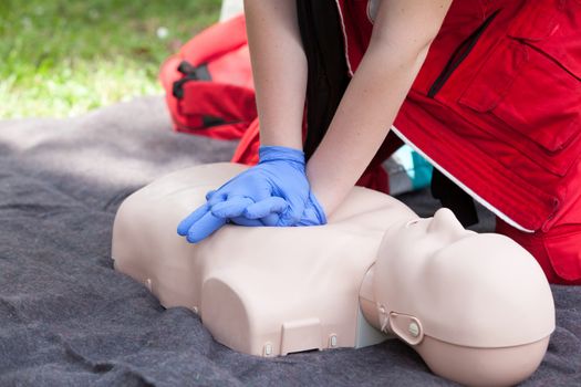 First aid training. Instructor showing CPR on training doll.