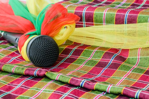 microphone is encased with a rag and place it on a piece of colorful cloth