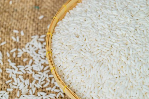 Glutinous rice in bamboo Basket with hemp sacks background