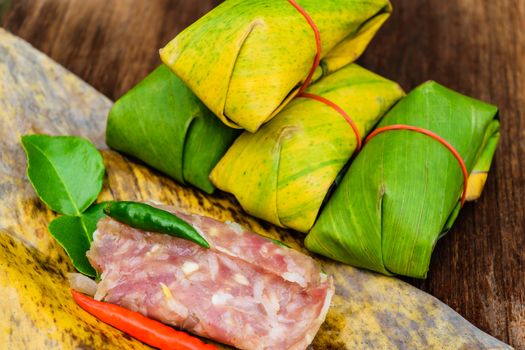 Sour pork Thai northeastern style food which mixed pork rice garlic sugar and salt in banana leaf package.