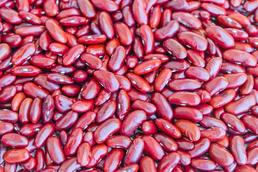 Uncooked peeled dry red kidney beans closeup for background.
