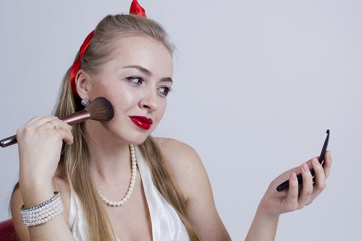 Young beautiful girl in pin-up style on a white background