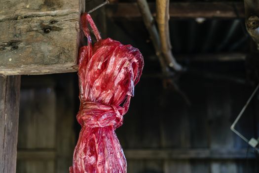 Red plastic rope rope on blur barn background