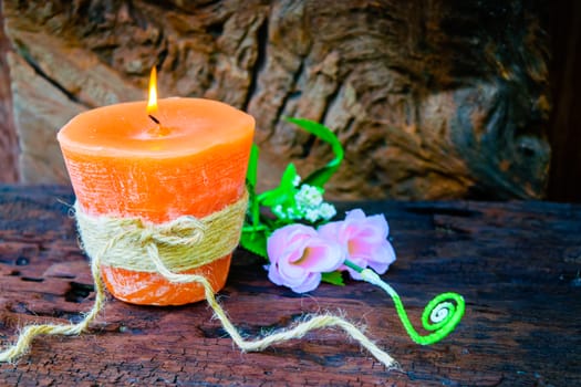 candle and flowers plastic beautiful on wood table