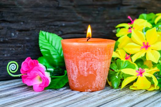 candle and flowers plastic beautiful on wood table