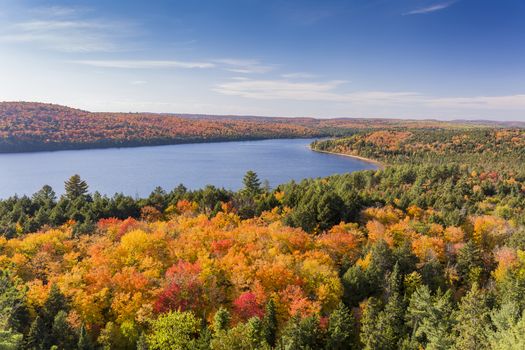 Overlooking a lake surrounded by brilliant fall foliage - Algonquin Provincial Park, Ontario, Canada