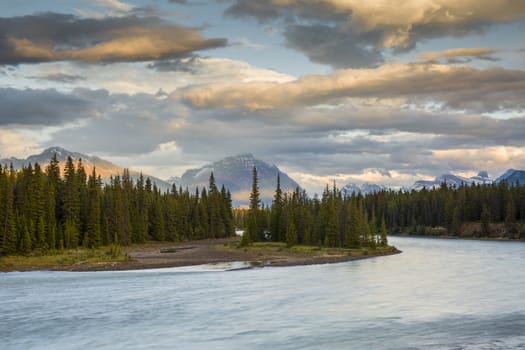 Athabasca River at sunset with Rocky Mountains in background - Jasper National Park, Alberta, Canada