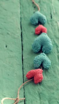 Group of valentine background with red and green heart on green wooden in vintage color, knitted heart is symbol for romantic love of couple in feb 14