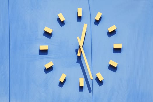 Yellow clock on a Blue Wall
