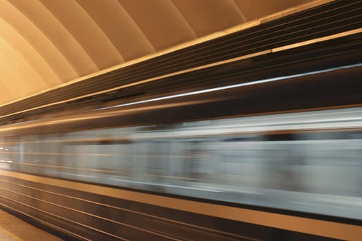 Subway platform with moving fast train