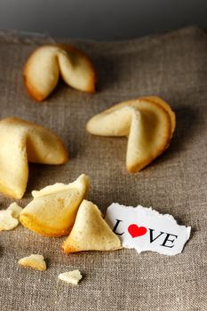 Cookies shaped like tortellini with the word love written on a paper.Vertical image.