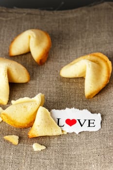 Cookies shaped like tortellini with the word love written on a paper.Vertical image.