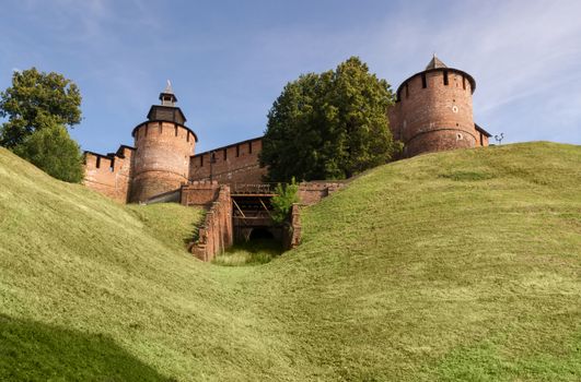 The towers and walls of the Nizhny Novgorod Kremlin on a green hill. Bottom view.
