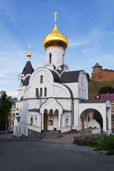 Old white Church on the background of the Kremlin towers and the blue sky in Nizhny Novgorod.