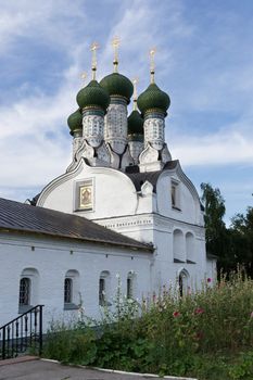 The old Church with green domes on blue sky background in Nizhny Novgorod. Decorated with tiles.