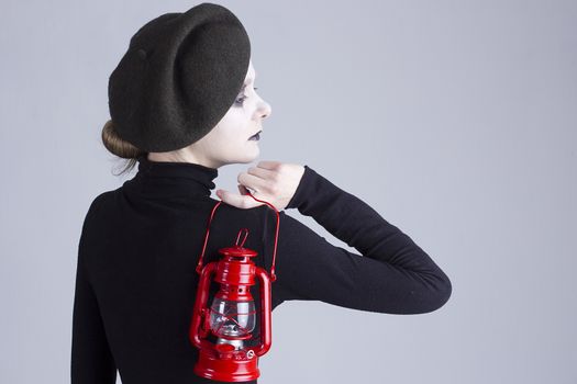 Young woman mime with red lantern