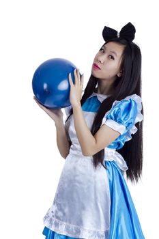 Young girl in the image of Alice with blue ball