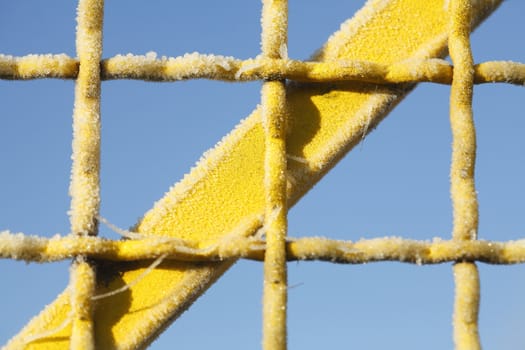 with  hoarfrost  coated  yellow metal fence