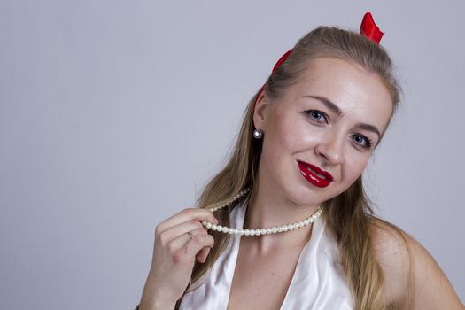 Young beautiful girl in pin-up style on a white background