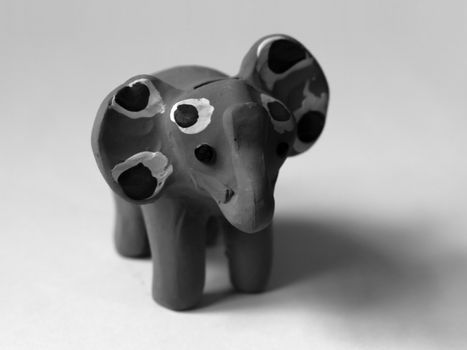 BLACK AND WHITE PHOTO OF PINK ELEPHANT TOY