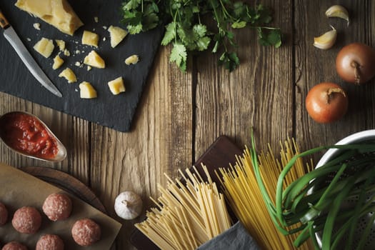 Ingredients for cooking spaghetti, meatballs with cheese and fresh herbs horizontal copy space