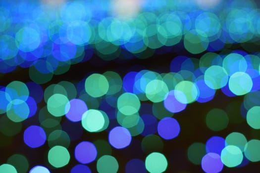 Background Winter illumination colorful blue LED blurred lights in horizontal frame