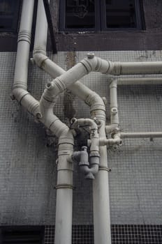 Old grunge building structure with pipes. Urban background