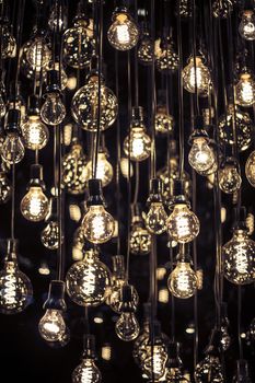 Group of hanging filament lamps on black background