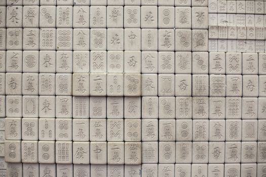 Wall of chinese characters on bricks. White background