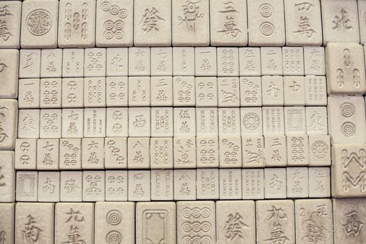 Wall of chinese characters on bricks. White background