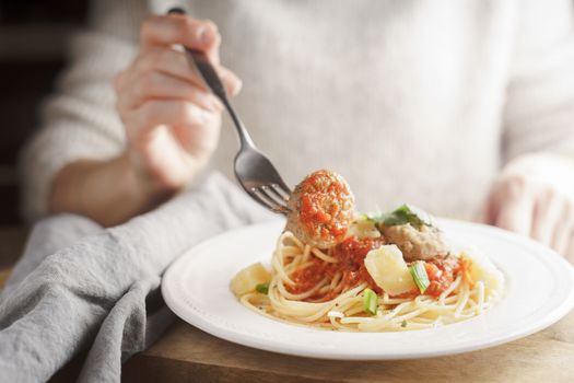 Woman eating meatballs horizontal