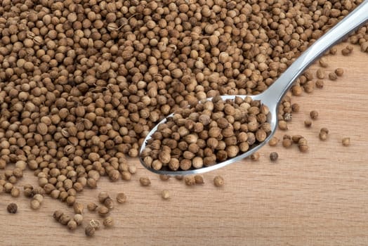 Organic Coriander seeds on wooden cutting boards background