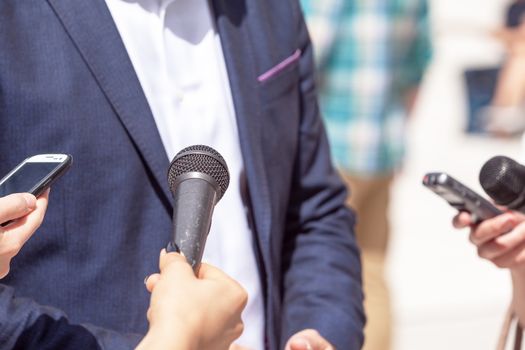 Journalists making interview with businessman, politician or spokesperson. News conference.