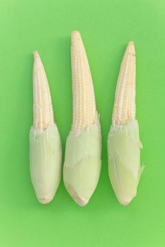 Baby Corns on green background