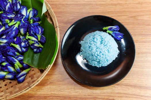 Blue Rice made cooking from Butterfly Pea flower (Clitoria ternatea L) in the black dish. Rice has a colorful and fragrant flower and good for health.