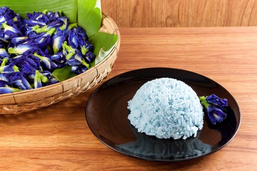 Blue Rice made cooking from Butterfly Pea flower (Clitoria ternatea L) in the black dish. Rice has a colorful and fragrant flower and good for health.