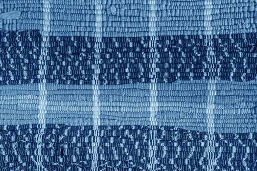 background, texture of colored handmade carpet. Fabric rug of small patches