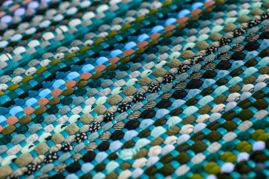 background, texture of colored handmade carpet. Fabric rug of small patches