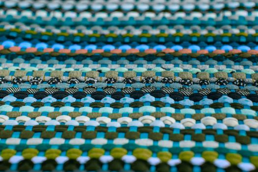 background, texture of colored handmade carpet. Fabric rug of small patches