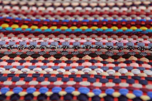 background, texture of colored handmade carpet. Fabric rug of small patches