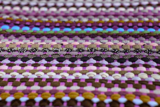 background, texture of colored handmade carpet. Fabric rug of small patches