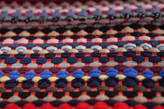 background, texture of colored handmade carpet. Fabric rug of small patches